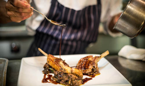 Chef plating up food on a plate