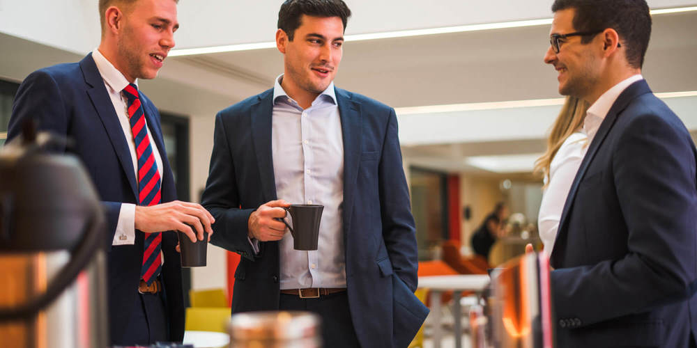 Colleagues chatting over coffee
