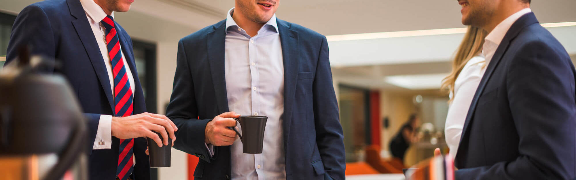 Colleagues chatting over coffee