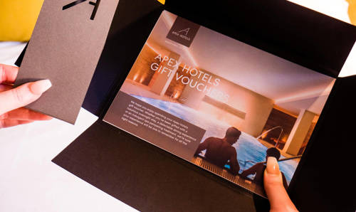 Apex Hotels gift voucher Hands holding an Apex Hotels gift voucher