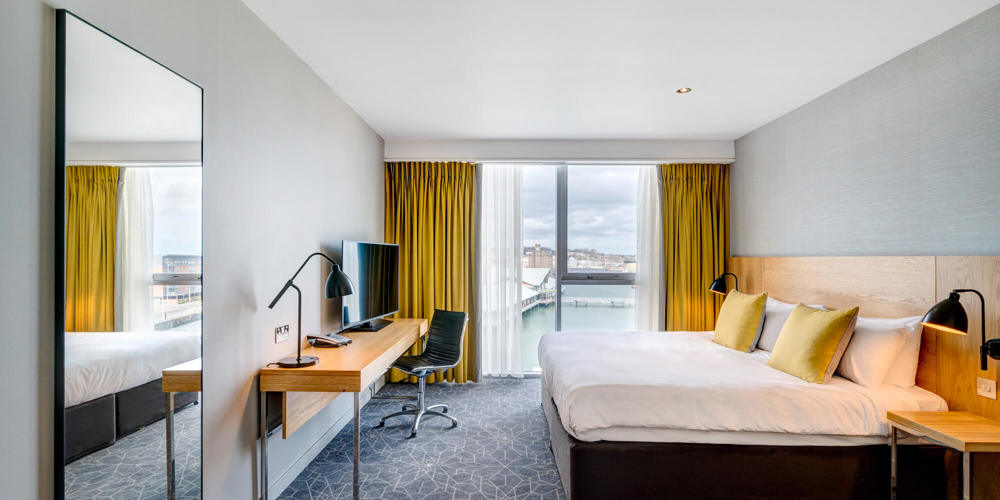 King size bed, desk and views looking out to the city quay