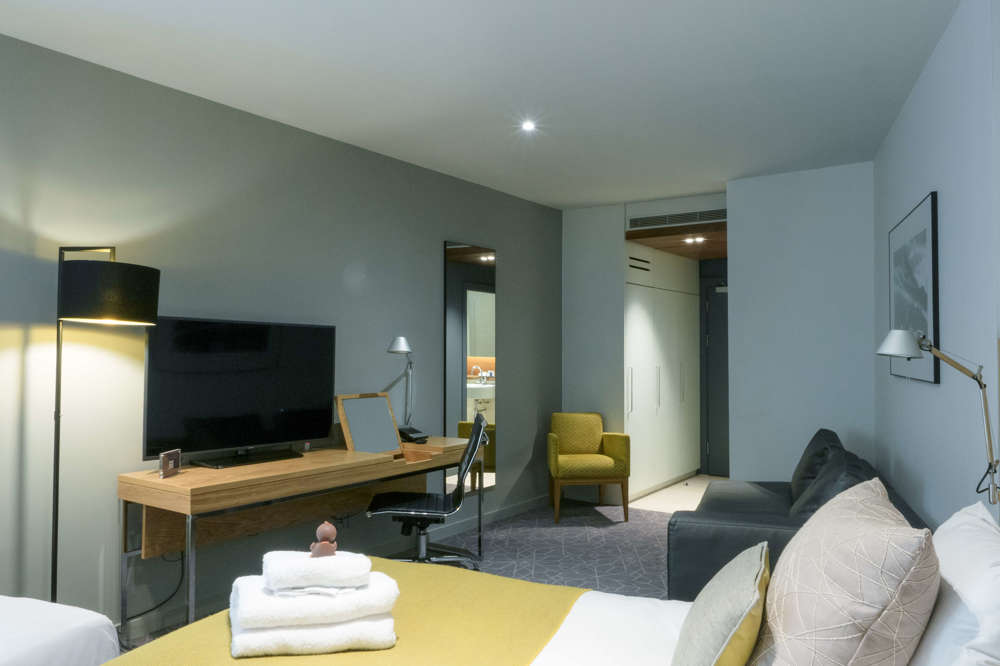 Family Room bed and tv at Apex Waterloo Place Hotel