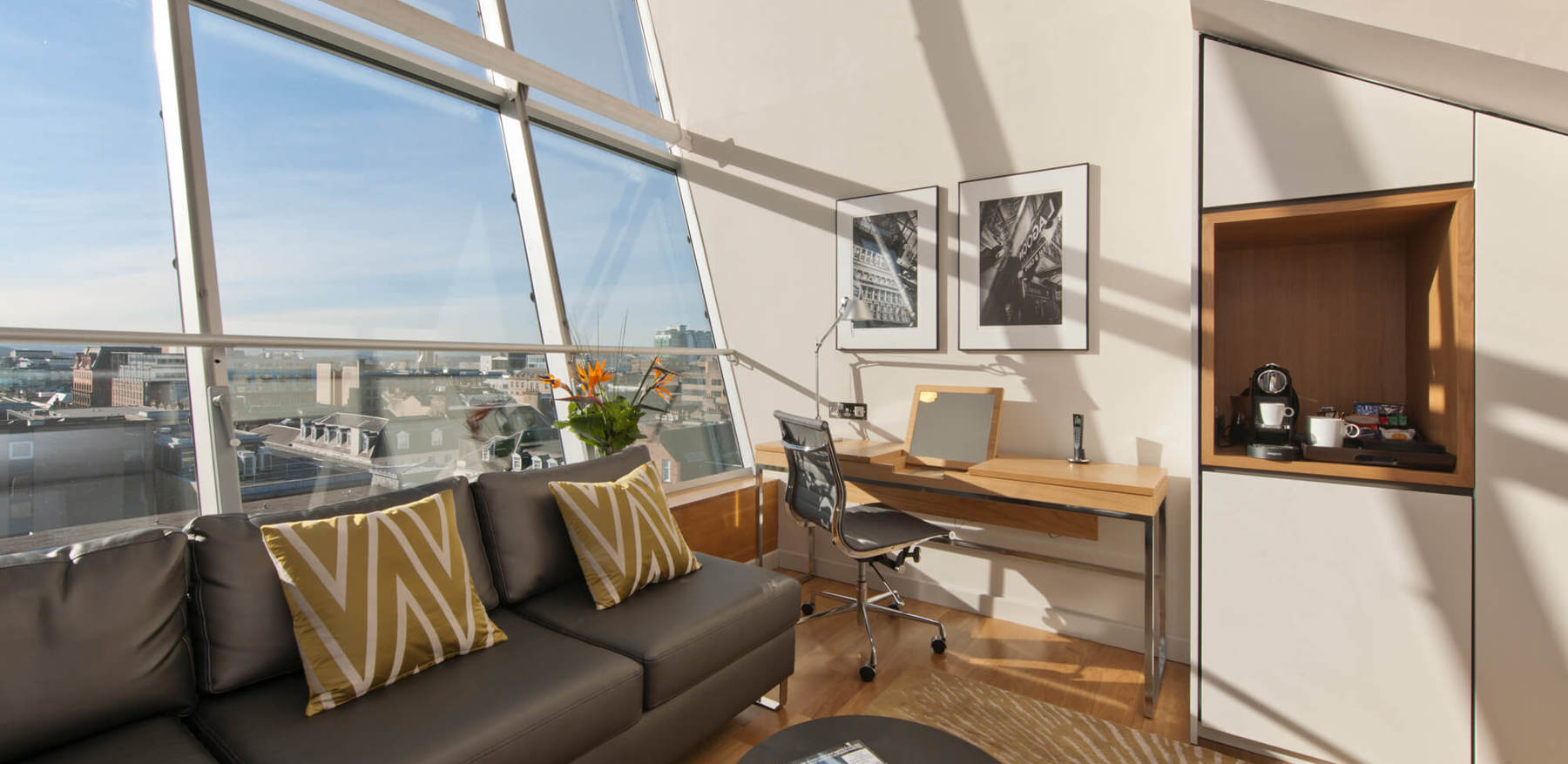 Duplex Suite lounge area with sofa and TV and city view