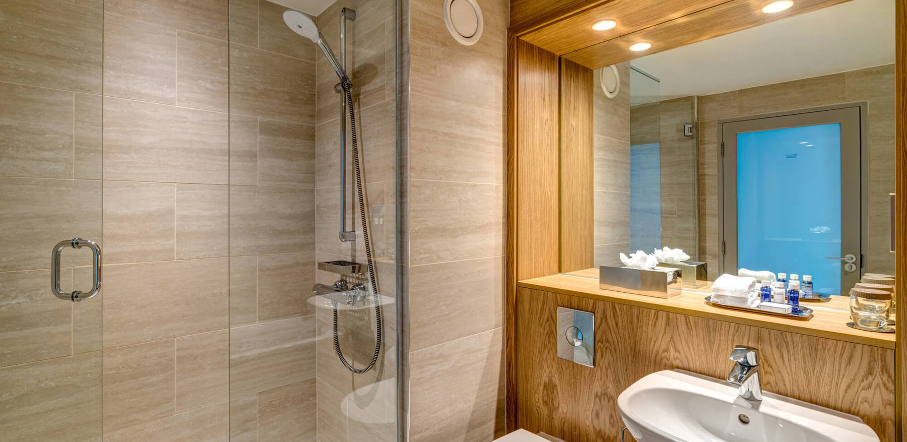 Walk-in shower next to sink in bathroom