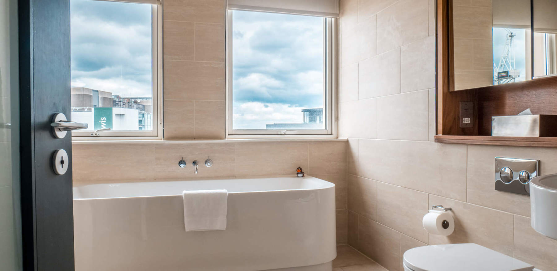 Deluxe Room bathroom with freestanding bath at Apex Waterloo Place Hotel