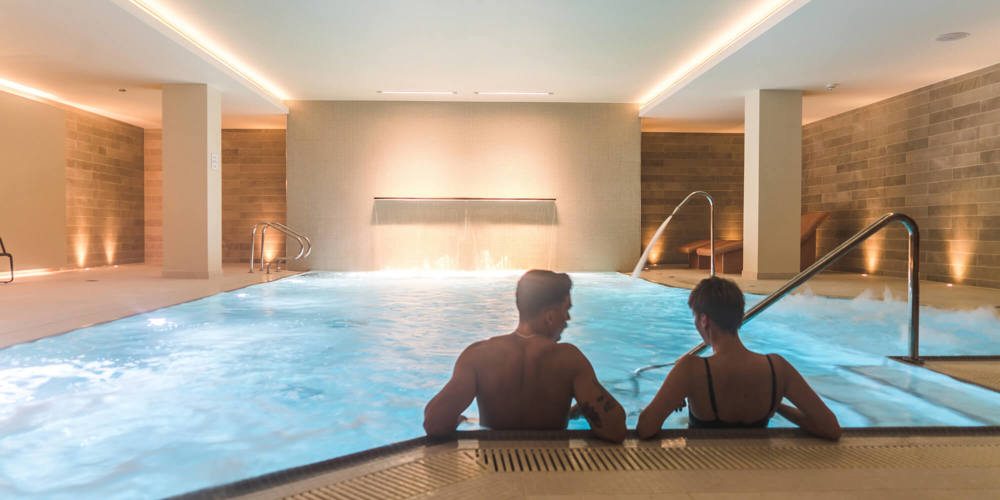Two guests relaxing in pool at Apex City of Bath Hotel