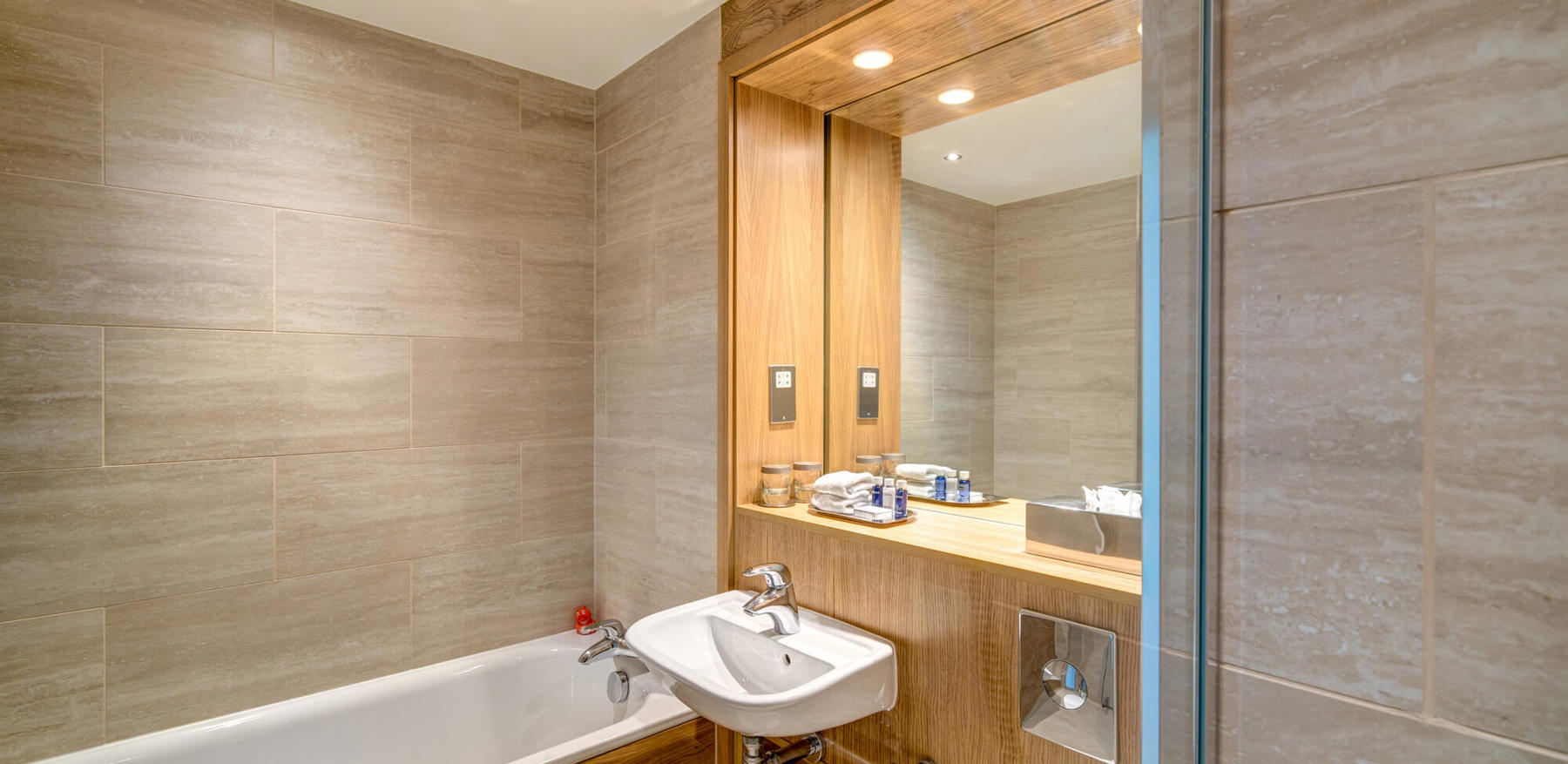 Bathroom with bath tub and sink with mirror