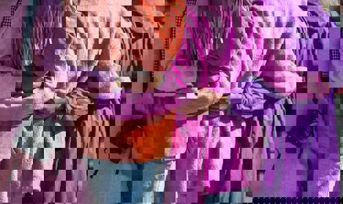 women with arms wrapped around each other