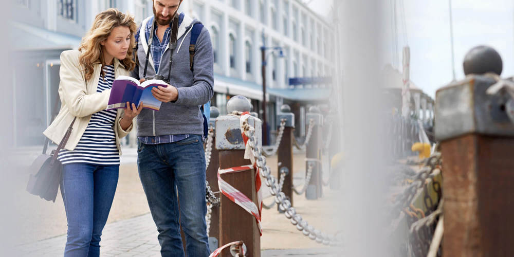 Tourist couple looking at map