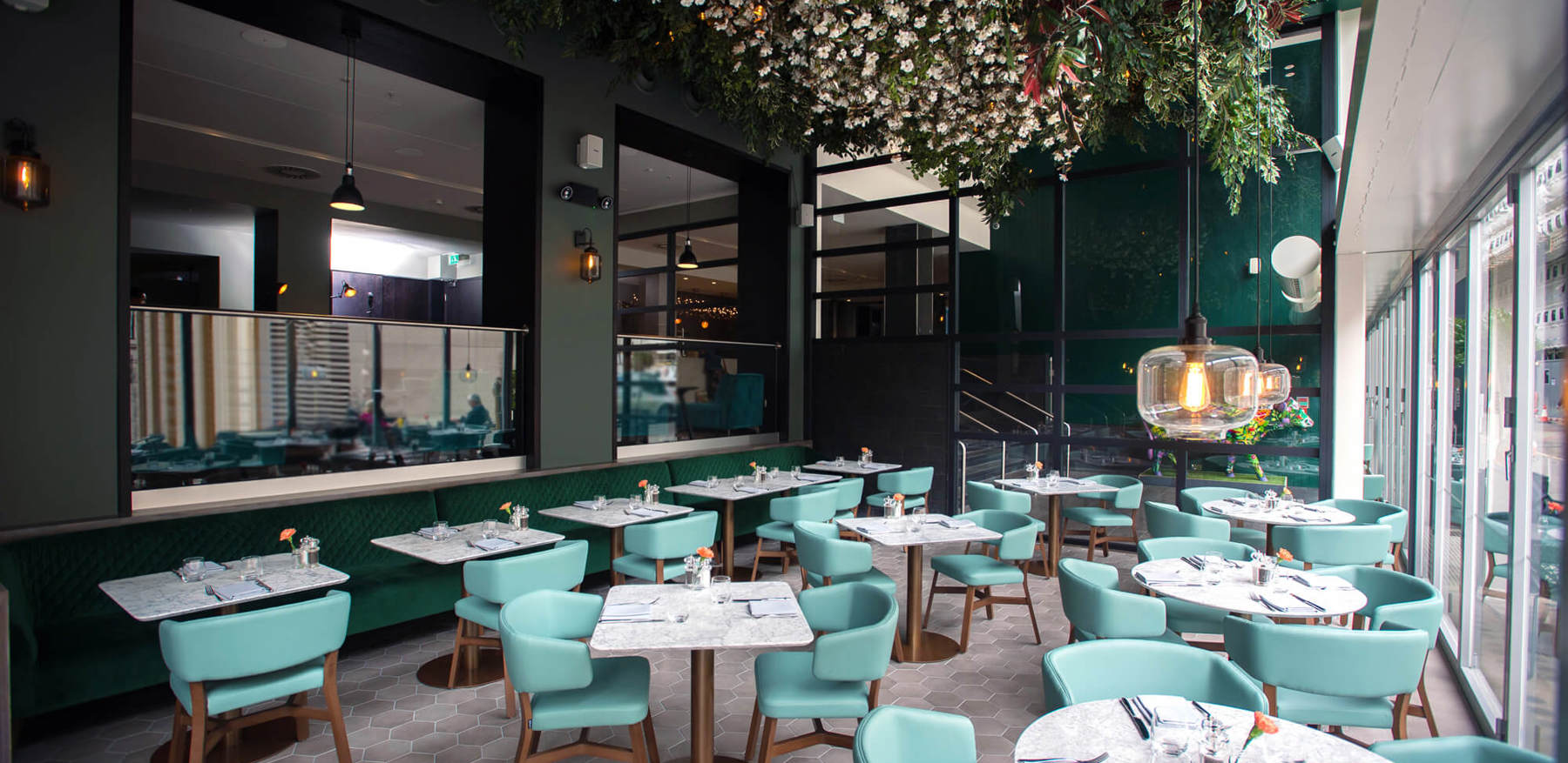 Inside Of Empty Restaurant With Floral Ceiling Decor & Blue Interior